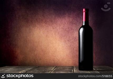 Bottle of red wine on wooden table and burgundy background