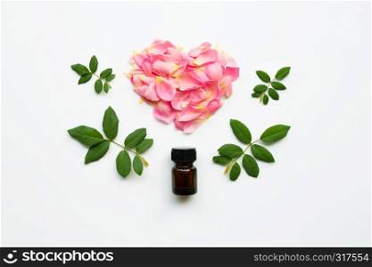 Bottle of rose essential oil for aromatherapy on white background.
