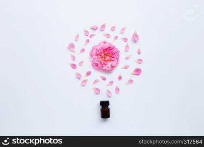 Bottle of rose essential oil for aromatherapy on white background.