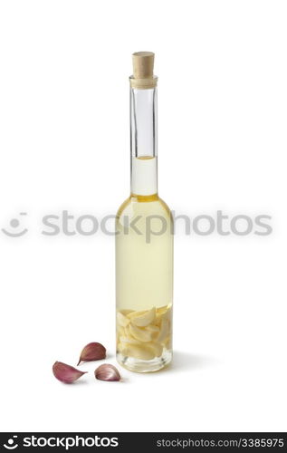 Bottle of Sunflower oil with garlic on white background