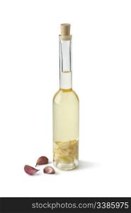 Bottle of Sunflower oil with garlic on white background