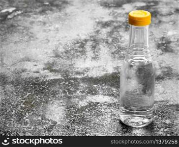 bottle of vinegar. On rustic background. bottle of vinegar.
