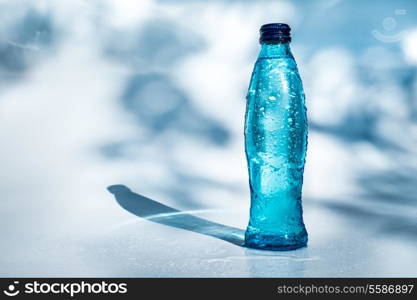 Bottle of water on blue background