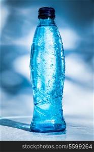 Bottle of water on blue background