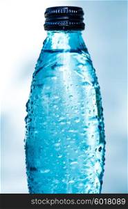 Bottle of water on blue background
