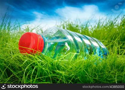 Bottle of water on the green grass.
