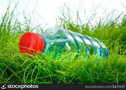Bottle of water on the green grass