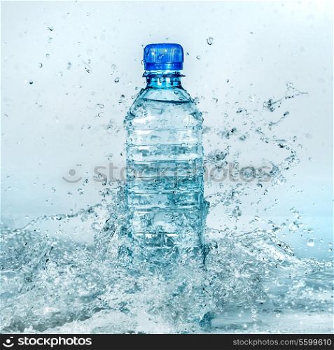 Bottle of water splash on a blue background