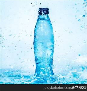 Bottle of water splash on a blue background