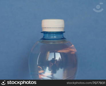 bottle of water with copy space. bottle of water over a blue background with copy space