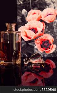 bottle of whiskey on a background of red poppies