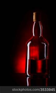 bottle of whiskey on deep red background