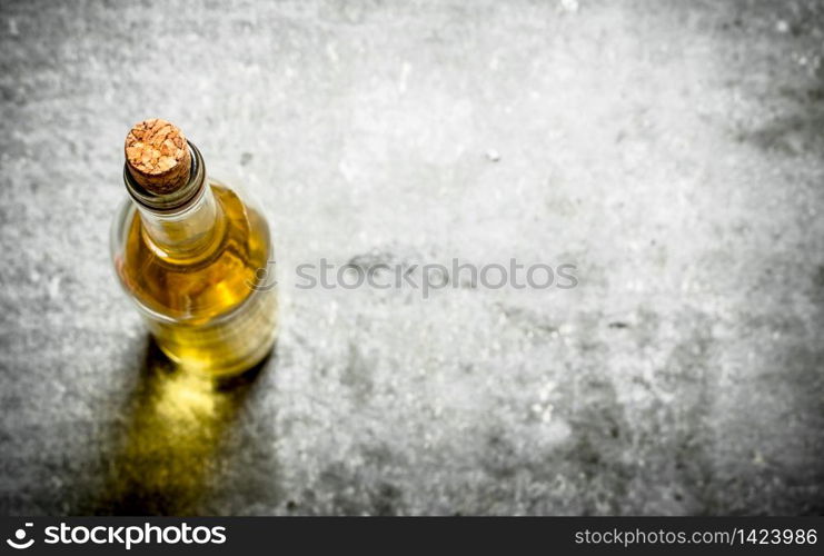 bottle of white wine. On the stone table.. bottle of white wine.