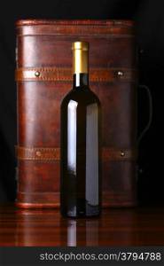 Bottle of white wine with a wooden case in the background