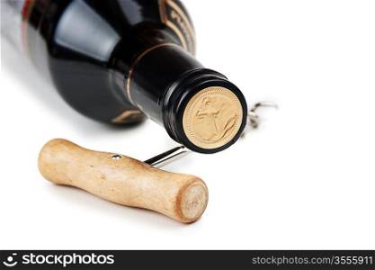 bottle of wine and a corkscrew isolated on white background