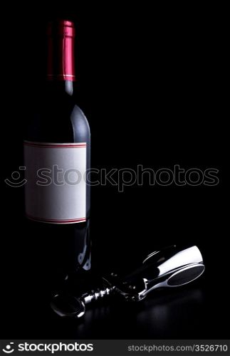 bottle of wine and corkscrew isolated on black background