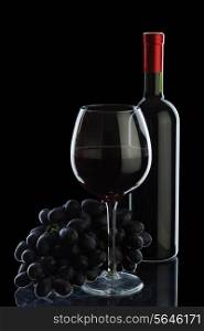Bottle of wine and grapes isolated on black background