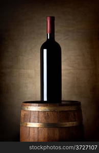 Bottle of wine on an old barrel