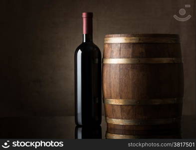 Bottle of wine on an old barrel