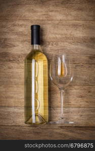 Bottle of wine with glass on wooden background