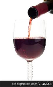bottle pouring red wine into a crystal glass (isolated on white background)