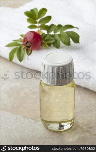 Bottle rose hip oil and fresh rose hips