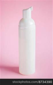 Bottle with cosmetic cleanser on a pink background. Skin care concept.. Bottle with cosmetic cleanser on pink background. Skin care concept.