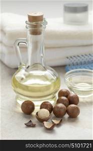 Bottle with cosmetic macadamia oil and nuts