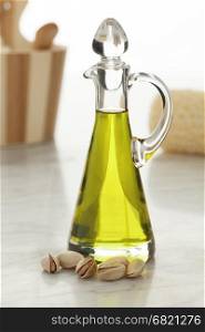Bottle with cosmetic pistachio oil and unshelled nuts