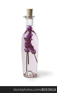 Bottle with lavender vinegar on white background