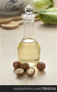 Bottle with macadamia oil and nuts