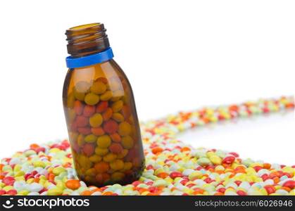 Bottle with many colourful pills