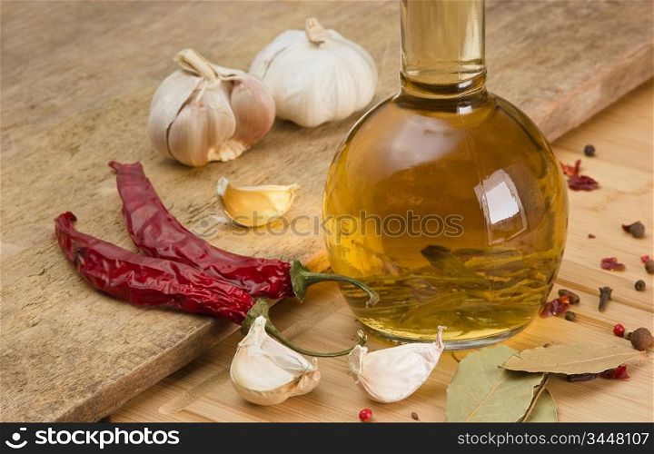 bottle with marinade and spices on a wooden table