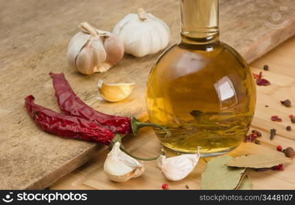 bottle with marinade and spices on a wooden table