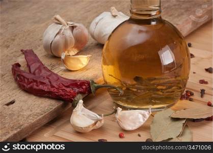 bottle with marinade and spices on a wooden table