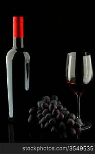 bottle with red wine and glass and grapes