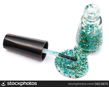 bottle with spilled multicolored glitter nail polish on white background