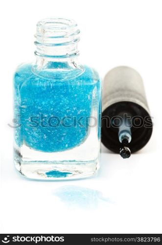 bottle with spilled turquoise nail polish on white background