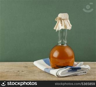 bottle with vegetable oil on a wooden table