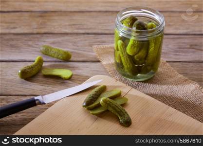 bottled pickles cucumbers in vintage wooden table