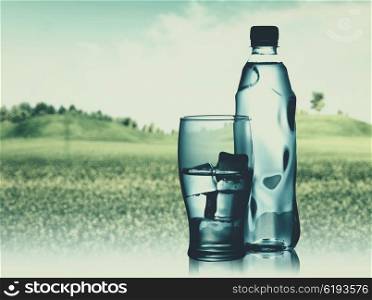 Bottled spring mineral water against abstract natural backgrounds