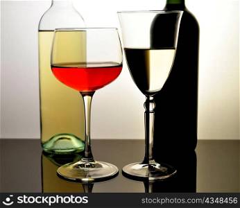 bottles and glasses red and white wine