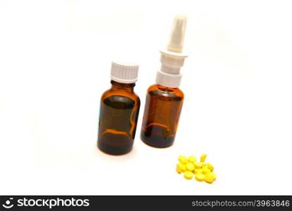 Bottles and tablets on white background