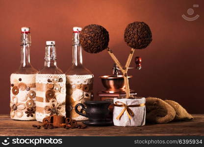 Bottles decorated with coffe beans, cinnamon and lace. The coffee decorations
