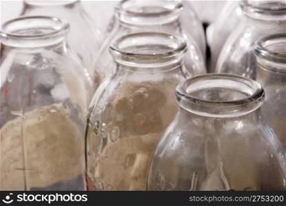 Bottles from under milk. Old, dirty prepared for recycling container