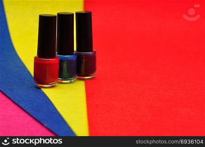Bottles of colorful nail polish displayed against a multi color background