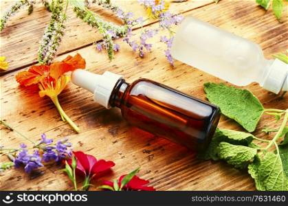 Bottles of essential oil with fresh herbs and flowers.Alternative healthy medicine. Aroma essential oil