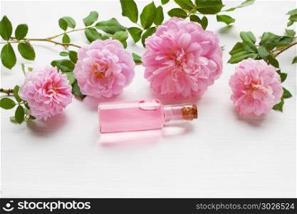 Bottles of essential rose oil for aromatherapy, Huntington Rose.. Bottles of essential rose oil for aromatherapy on white, Huntington Rose.