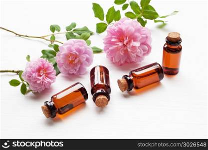 Bottles of essential rose oil for aromatherapy, Huntington Rose.. Bottles of essential rose oil for aromatherapy on white, Huntington Rose.