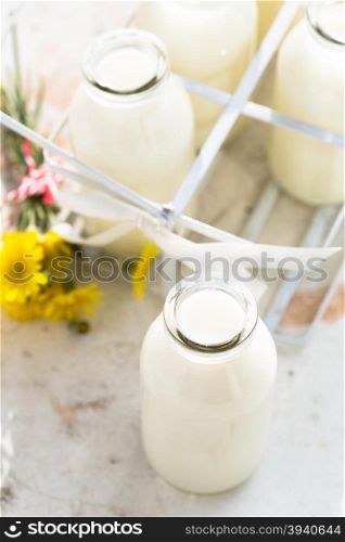 Bottles of fresh milk on a kitchen table